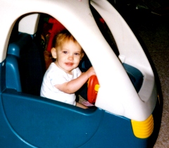 Hannah age 18 months driving in a toy car