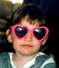 Hannah age 3 with big heart shaped sun glasses